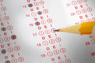 A scantron answer sheet with a pencil filling in some of the bubbles, but instead of being labeled A, B, C, the bubbles are labeled D, E, I.