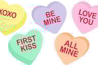 An illustration of five Valentine's Day–themed candy hearts, of different pastel colors, with messages variously saying "XOXO," "Be Mine," "Love you," "All Mine" and "First Kiss."