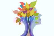 An illustration, depicting the concept of a growth mindset, of a human head with a tree sprouting from it, a tree with many multi-colored leaves.