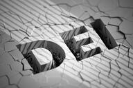 The letters DEI against the background of what appears to be a wall with many cracks.