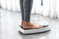 Young girl on home scale