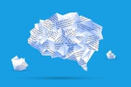 An illustration of a human brain made out of different pieces of paper with typed text on them, against a blue background.