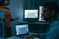 Female programmer is giving an interactive training session, focusing on hands-on learning in digital classroom environment. Software developer, artificial intelligence and programming concept.