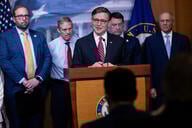 Mike Johnson stands at a podium flanked by other House lawmakers
