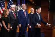 U.S. Speaker of the House Mike Johnson flanked by other congressional Republicans speaks at a podium.