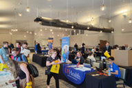 Students walk through a career fair in a conference center space