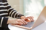 Woman using computer chatting with an artificial intelligence asks for the answers wants