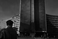 A black-and-white photo of a large concrete office building