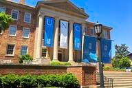 A building at UNC decorated with Tar Heel blue and white banners