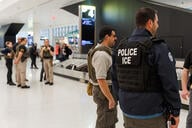 Immigration agents are seen inside Newark Liberty International Airport's Terminal A in Newark, N.J., on March 23, 2026. 
