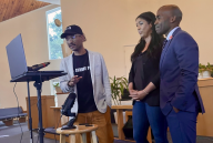 Three individuals stand inside a church during a 24-hour teach-in last week.