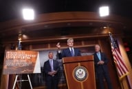 Senator Bill Cassidy and others speak at a podium about their latest proposal to lower the cost of higher education.