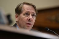 Richard Cordray speaks into a microphone