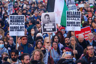 Protesters hold signs with Mahmoud Khalil's face on them to protest his arrest