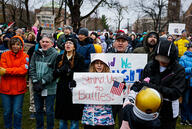 Protesters hold signs including "Harvard: Protect International Students" and "Stand Up to Bullies!" during a Cambridge Common rally.