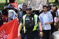 Campus police at the University of Central Florida walk amid student protesters.