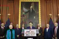 A group of Republican members of the House of Representatives, standing in front of a painting of George Washington and behind a podium that says "One Big Beautiful Bill Act."