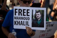 Protester with sign saying "Free Mahmoud Khalil"