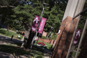 A view of the outside of an Augsburg University building including a banner hanging next to a walkway