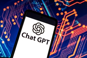 A smartphone with the words "Chat GPT" against an abstract background.