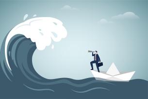 A businessperson in a paper boat uses a telescope to look at an oncoming wave.