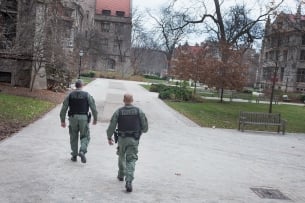 Two police officers walk through the University of Chicago campus.