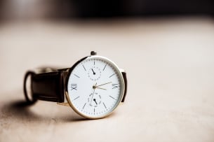 A photo of an analog wristwatch on a table. 