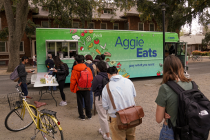 Students line up to receive a meal from the AggieEats food truck.