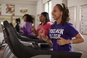 Four students at Spelman College run on treadmills.