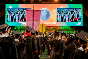 Graduates face the stage at the University of Miami's 2022 commencement ceremony.