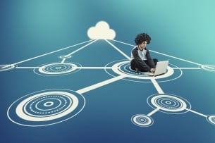Man sits working on computer in middle of network of hubs