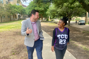 Jason Titus engages with a student on Texas Christian University's campus.