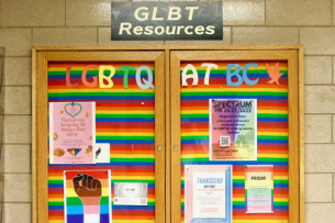 A rainbow-covered board at BC advertising LGBTQ+ resources