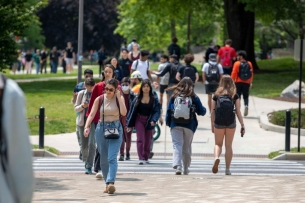 Students walk outside on a college campus 