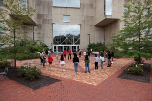 Students stand in a circle outside Indiana University–Purdue University Indianapolis