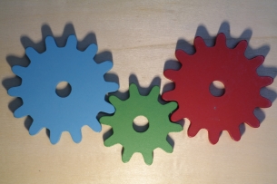 Three different colored wheels (blue, green, and red) attached together