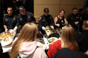 Cal Fire firefighters serve Camp Fire evacuees during a community Thanksgiving dinner at California State University, Chico