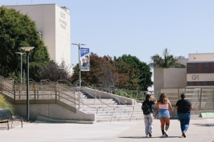 Three students walking on the campus of East Los Angeles College