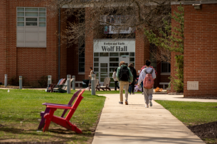 Students walk on York College's campus on a sunny day.