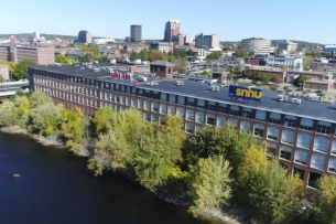 A aerial view of Southern New Hampshire University showing a building surrounded by trees.