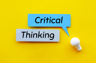 Two speech bubbles containing the words "Critical" and "Thinking" hover above a lightbulb against a yellow background.