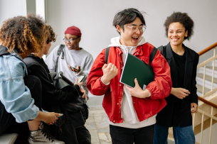 A group of students interact in a hallway.