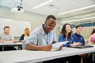 A group of students listens to a lecture at the University of West Florida.