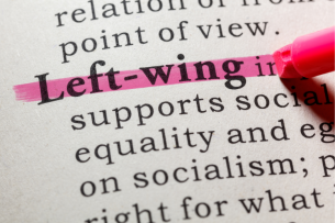 A close-up of a pink highlighter being used to highlight the entry for "left-wing" in a dictionary.