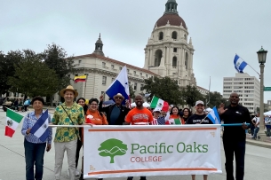 Pacific Oaks faculty, staff and students hold a banner during the Latino Heritage Parade and Festival in Pasadena.