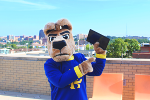 The University of Missouri Kansas City's mascot, a kangaroo, holds up a tablet on campus.