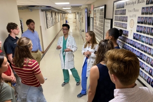 Two medical students at the University of Miami give a tour to Davidson College student athletes.
