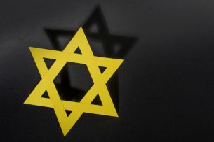 A yellow Star of David against a black background. 