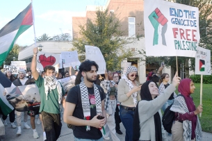Pro-Palestinian supporters holding flags and signs march on the University of Central Florida campus.