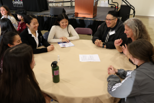 Students network with employers in a round table format at Santa Clara University's Diversity Works Expo event